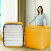 A woman stands next to a yellow heavy-duty waterproof storage bag, which is open to show neatly rolled white textiles.
