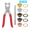 A set of precision eyelet punch and grommet tools including pliers, punches, and various rings.