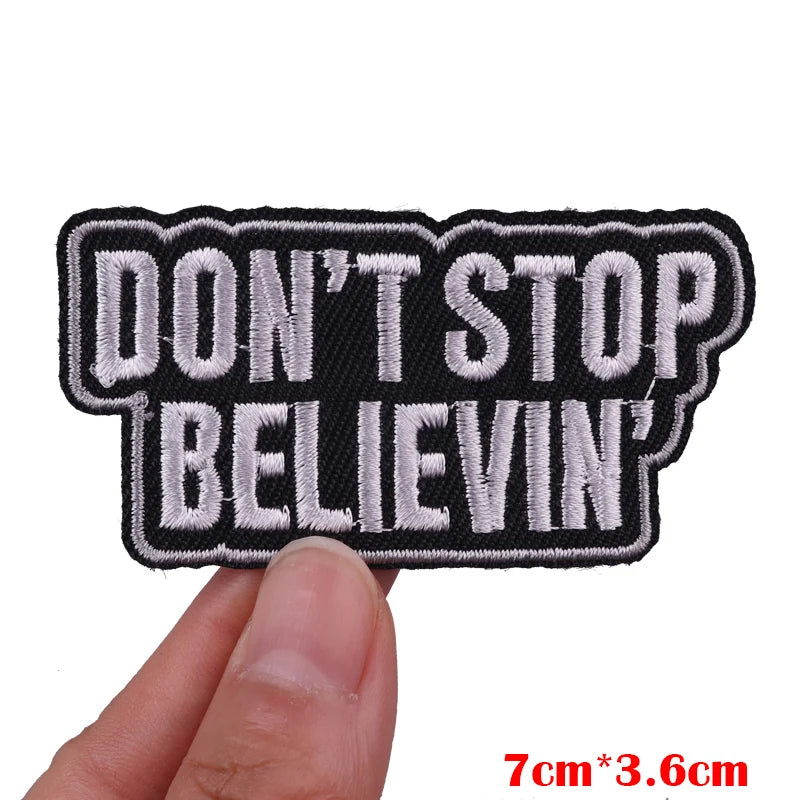 Black and white embroidered patch with the text DON'T STOP BELIEVIN'