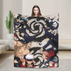 A flannel throw blanket featuring a graphic design of Jujutsu Kaisen characters and Gojo Satoru.