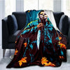 A dark horror-themed throw blanket featuring a figure resembling Michael Myers in blue and yellow tones.
