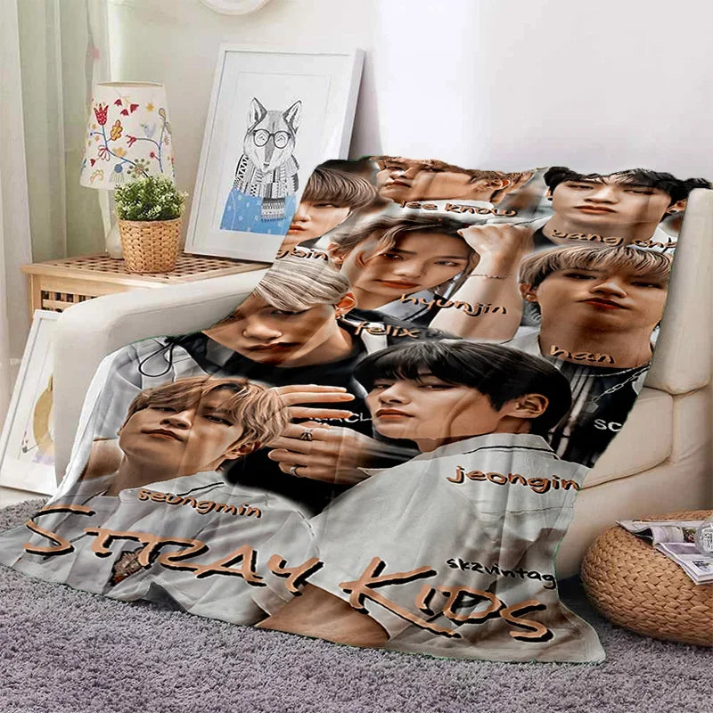 A 3D printed fleece throw blanket featuring multiple portraits of Stray Kids members.