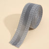 Roll of silver self-adhesive hem tape for fabric repair and shortening