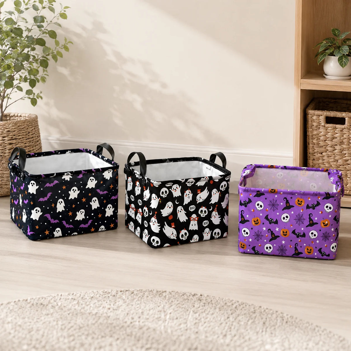 Three foldable Halloween storage baskets in black, white, and purple with spooky designs on a wooden floor.