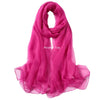 A vibrant pink sheer scarf draped elegantly, suitable for sensory play.