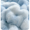 Close-up of soft light blue faux rabbit fleece fabric texture.
