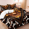 A bed covered with a brown and black Highland cow print duvet featuring a face design.