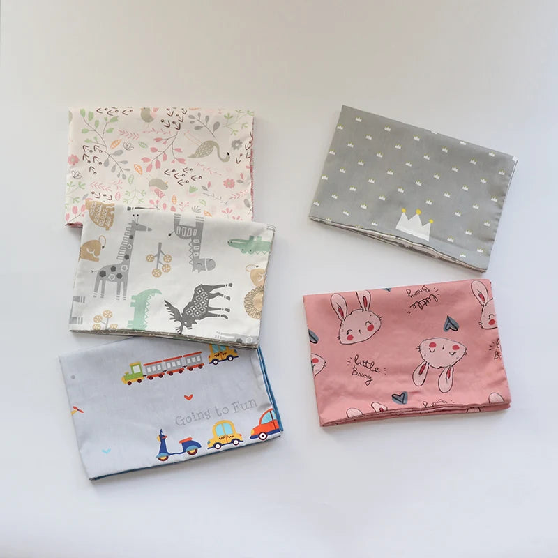 A collection of five soft cotton baby pillow covers featuring various animal and vehicle patterns in pink, gray, and white.