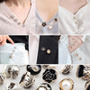 Close-up of instant removable pearl brooch buttons on white and black fabric.