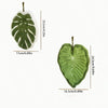 A green, leaf-shaped hand towel with a hanging hook, shown in profile and size measurements.
