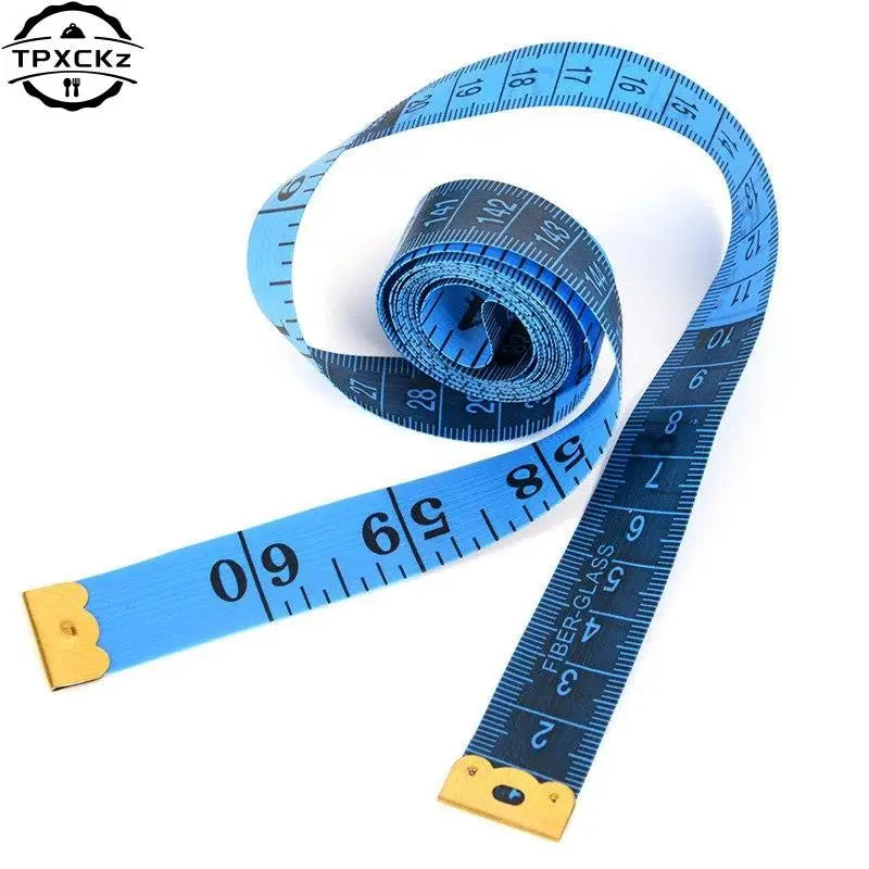 Blue flexible body measuring tape ruler coiled and laid out, showing various measurement markings.