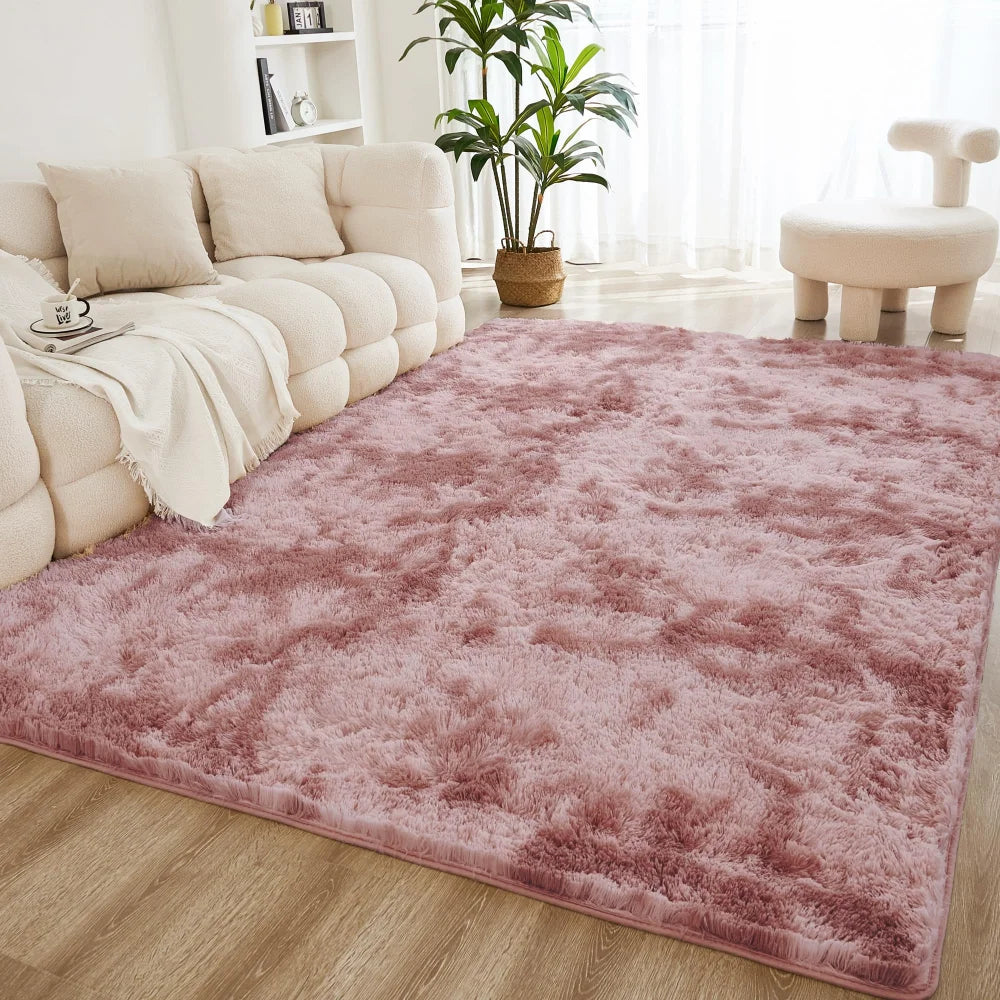 A pink shaggy rug is placed on a wooden floor in a bright living room setting.