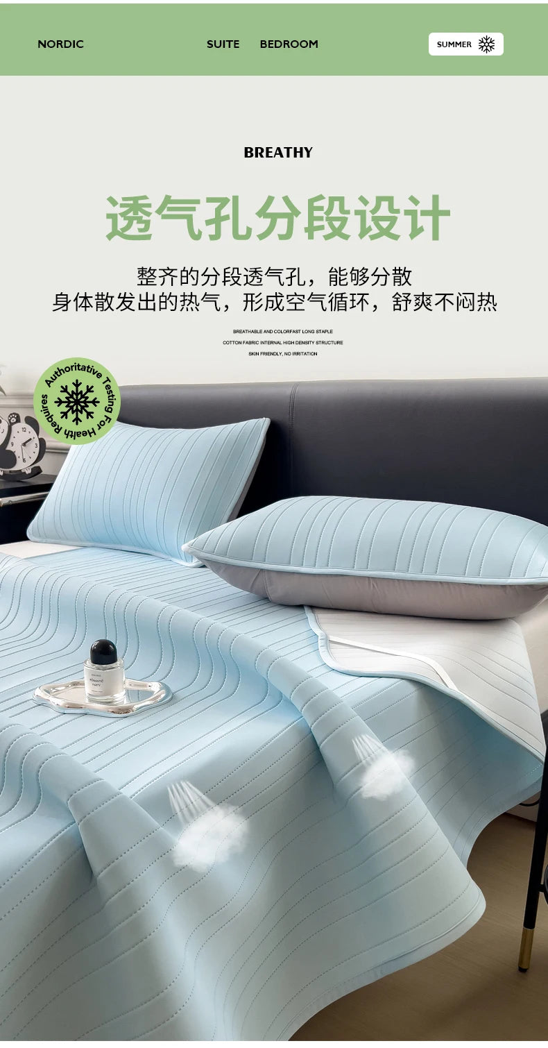 Light blue ice silk bed pad draped on a bed, showcasing breathable fabric design.