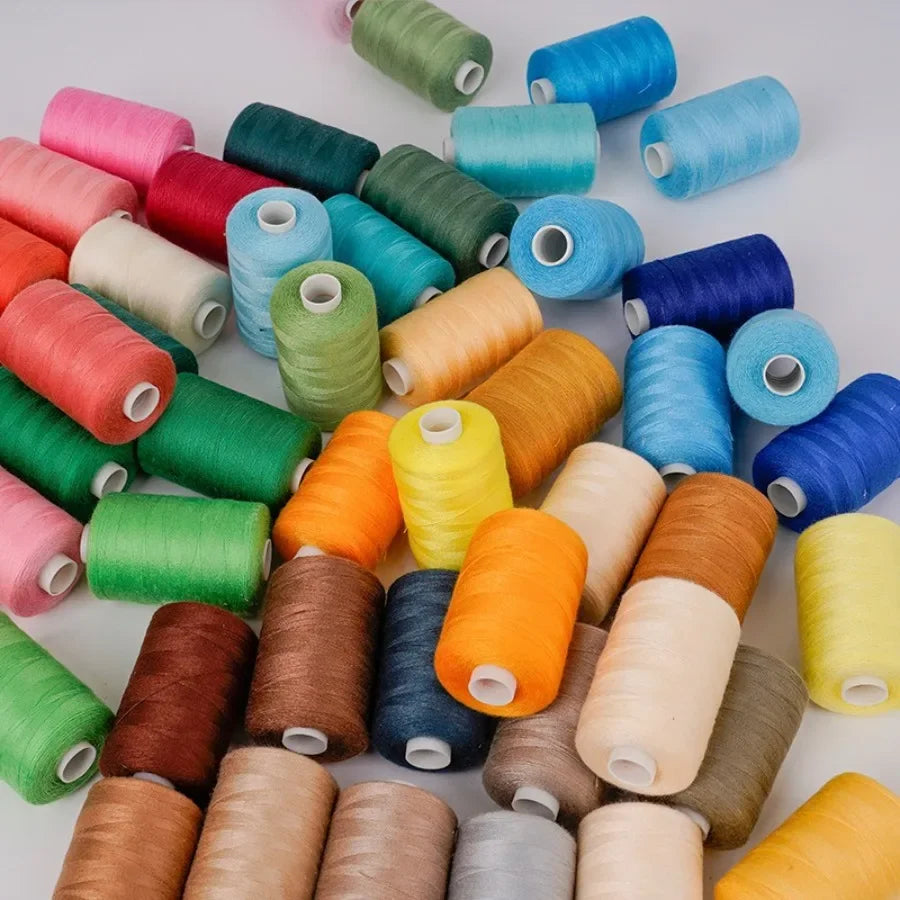 A collection of 10 rolls of high-quality polyester sewing thread in various shades of green, blue, yellow, and brown.
