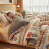 A person is relaxing under a thick, fluffy lamb'swool winter blanket in a bright bedroom setting.