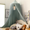 A light blue princess hanging bed canopy with sheer fabric and decorative fringe hanging from the top