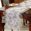 Elegant jacquard lace table runner with floral pattern on a dark wood table.