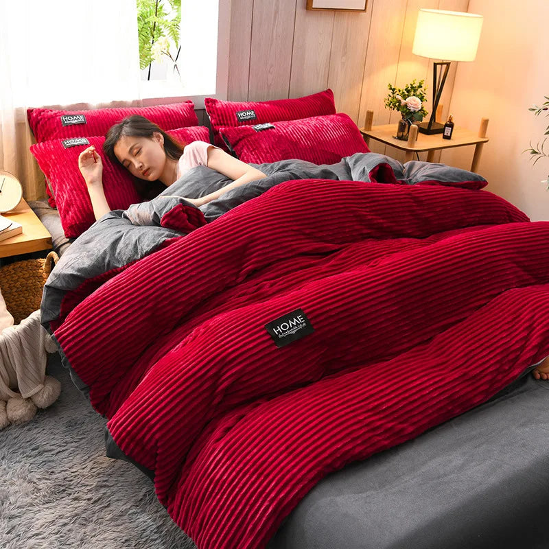 A woman is relaxing on a bed covered with a red corduroy duvet cover set.