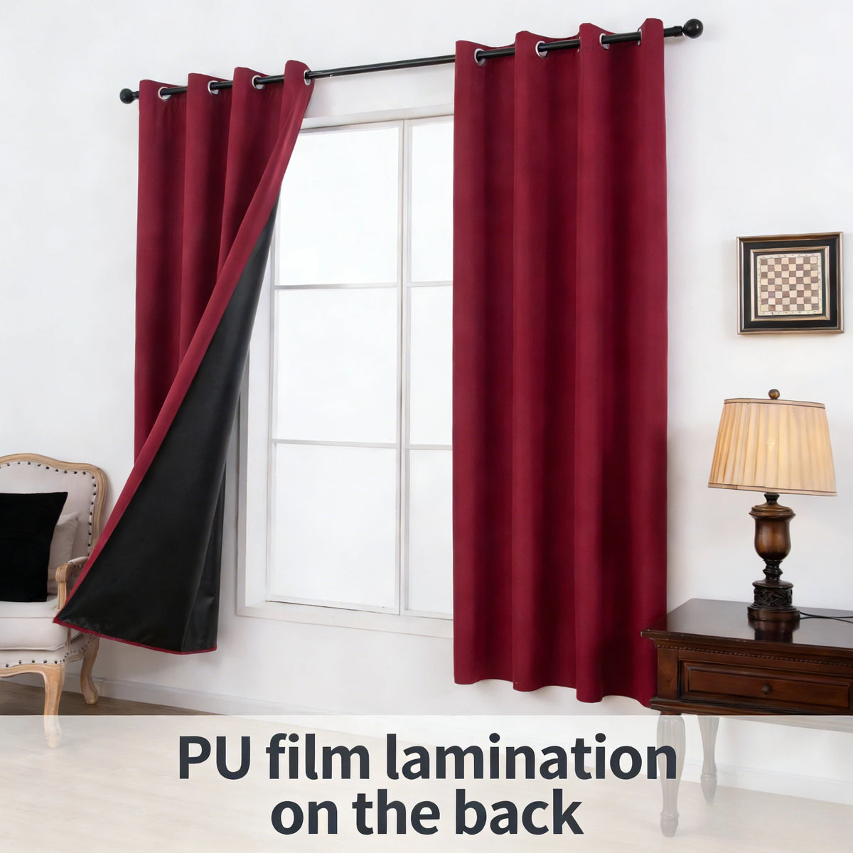 A pair of deep red curtains with black accents hanging in a window frame.