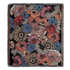 A dark throw blanket featuring a floral and geometric pattern in shades of pink, orange, blue, and cream.
