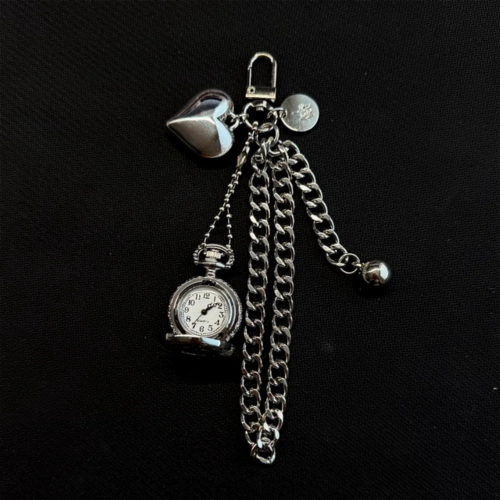 Silver star-shaped pocket watch keychain with a chain and a round clock face.