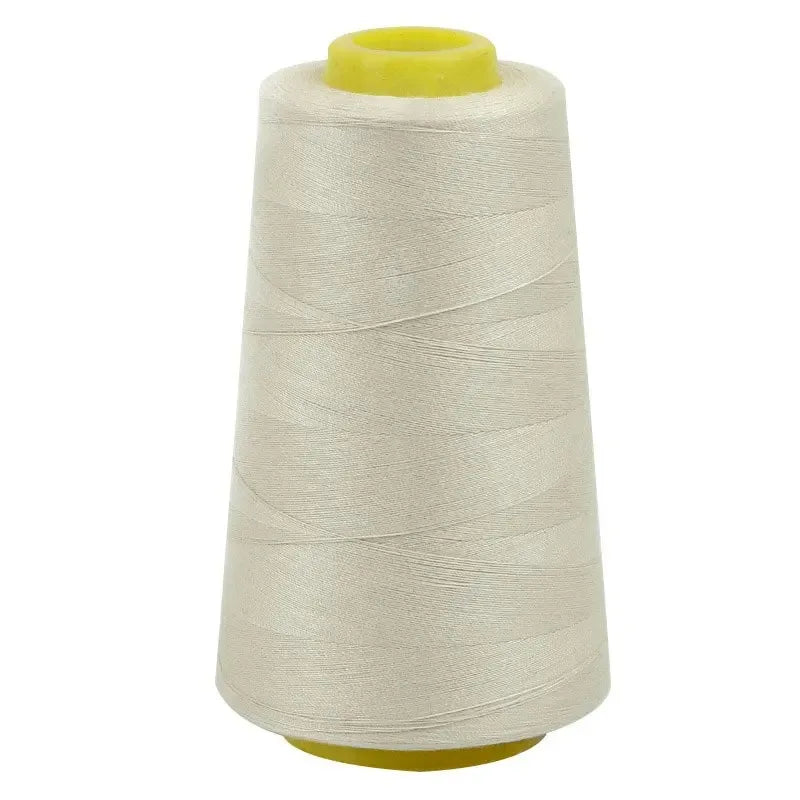 A roll of beige sewing thread with a yellow core.