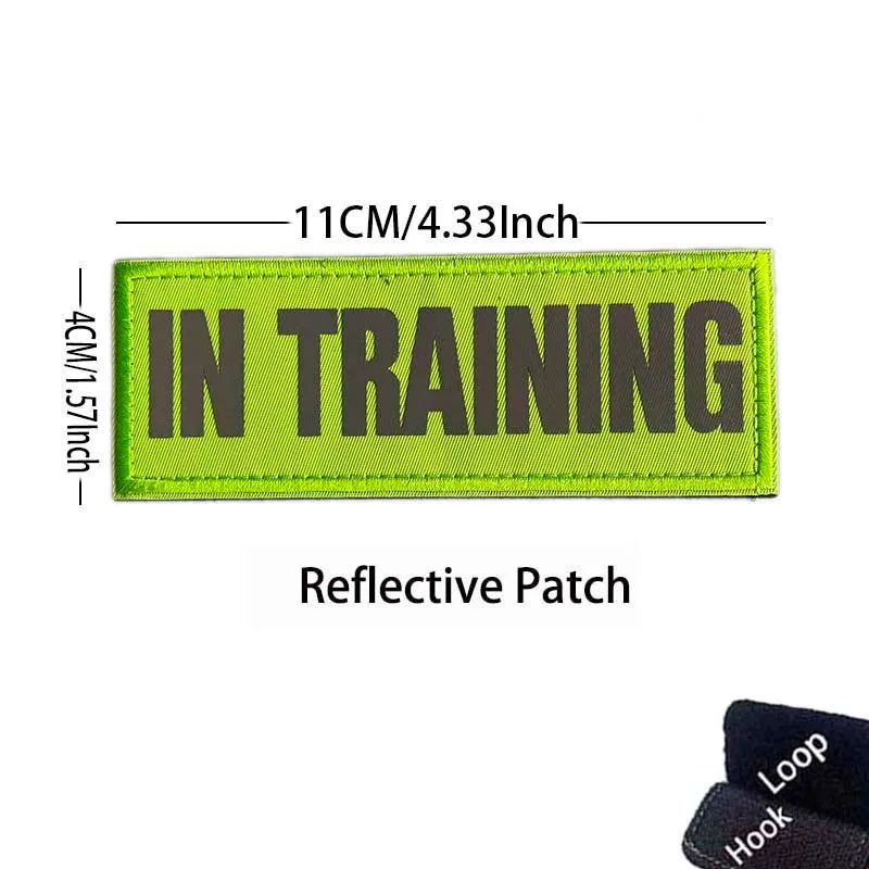 A bright lime green reflective patch embroidered with the text IN TRAINING