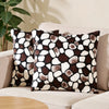 A set of two throw pillows with a brown and white leopard print pattern resting on a light-colored sofa.