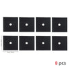 Eight black square gas stove protectors with white circular holes.
