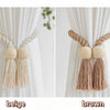 Hand-woven wooden curtain tiebacks in beige and brown colors displayed against a white curtain.