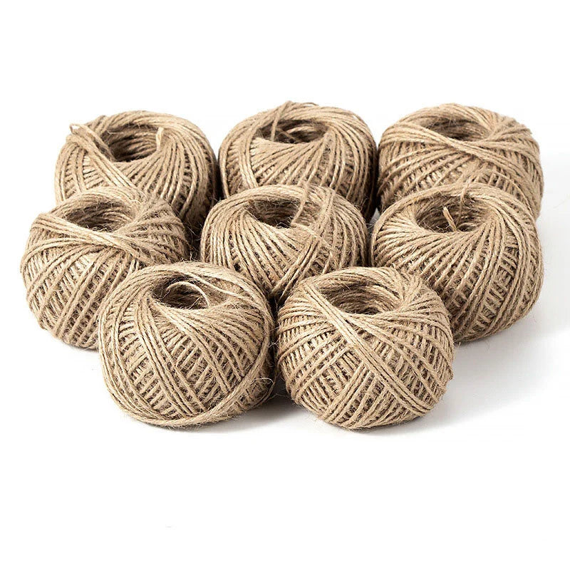 A pile of natural jute twine rolls used for crafts and decor.