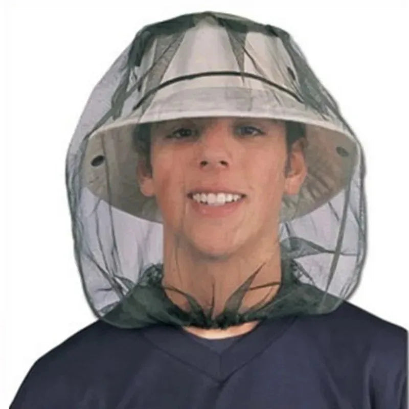 A young man wearing an extra large mosquito net with a face mask.