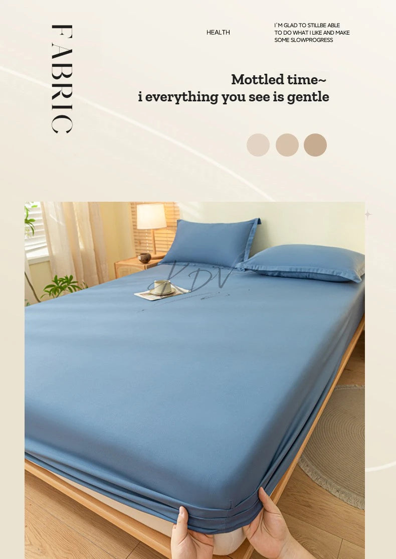 A close-up of a solid blue fitted sheet set with matching pillowcases on a bed.