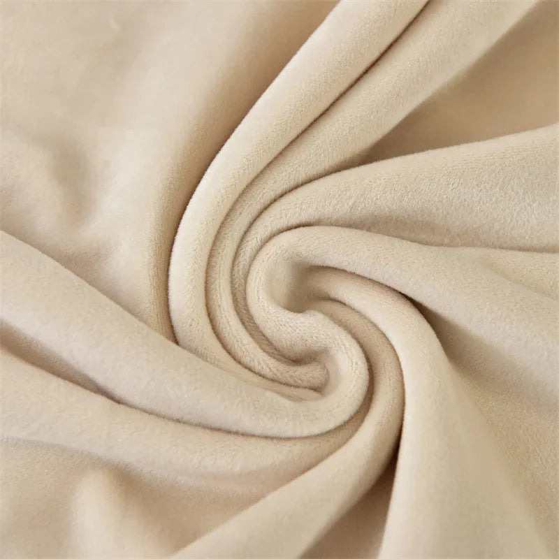 A close-up of a beige stretchy velvet bench slipcover fabric tightly rolled into a swirl.