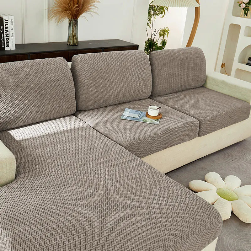 A modern gray jacquard knit sofa cushion cover with light beige accents and a textured pattern.