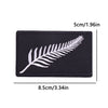 Black iron-on embroidery patch featuring a white feather design.