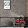 A roll of self-adhesive 3D thermal insulation wallpaper with a linen texture in gray.
