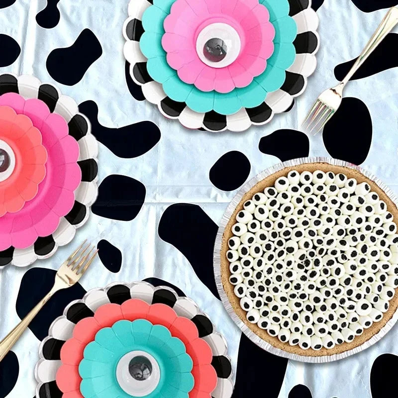 Pink and teal floral patterned disposable plastic tablecloths with black abstract shapes