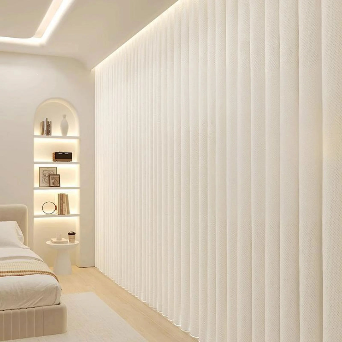 A vertical pleated white fabric room divider curtain in a modern interior setting.