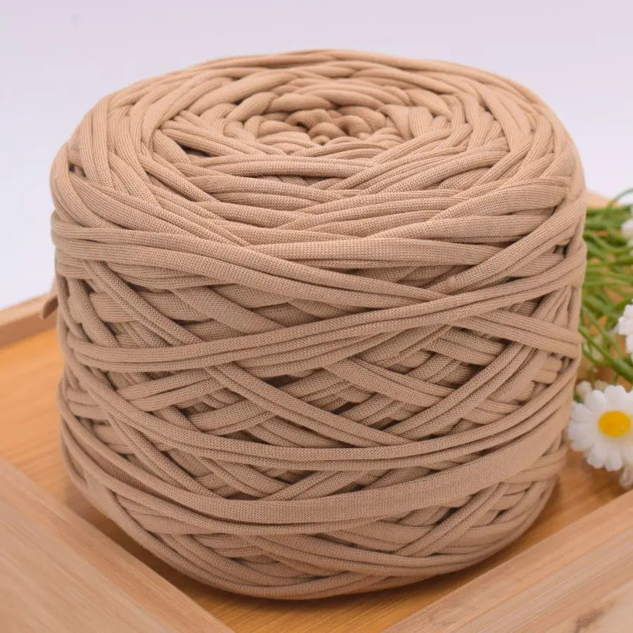 A ball of beige craft yarn made from 100% polyester for knitting and DIY projects.