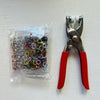 A pair of silver and red pliers with five jaws for clamping fabric and accessories.