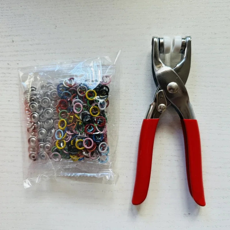 A pair of silver and red pliers with five jaws for clamping fabric and accessories.