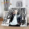 A black and white graphic throw blanket featuring text and a portrait of a man.