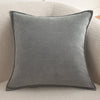 A square gray chenille throw pillow cover resting on a light beige sofa.