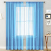 Light blue sheer curtain panels hanging over a window in a living room or bedroom.