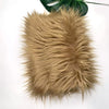 A fluffy, light brown faux fur fabric used for sewing and crafting.