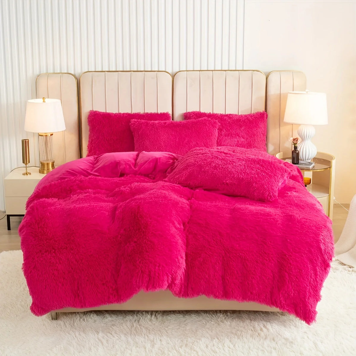 A vibrant pink plush duvet cover set displayed on a bed with upholstered headboards and bedside lamps.