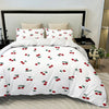 White duvet cover set featuring a fruit print design with red and green cherries.