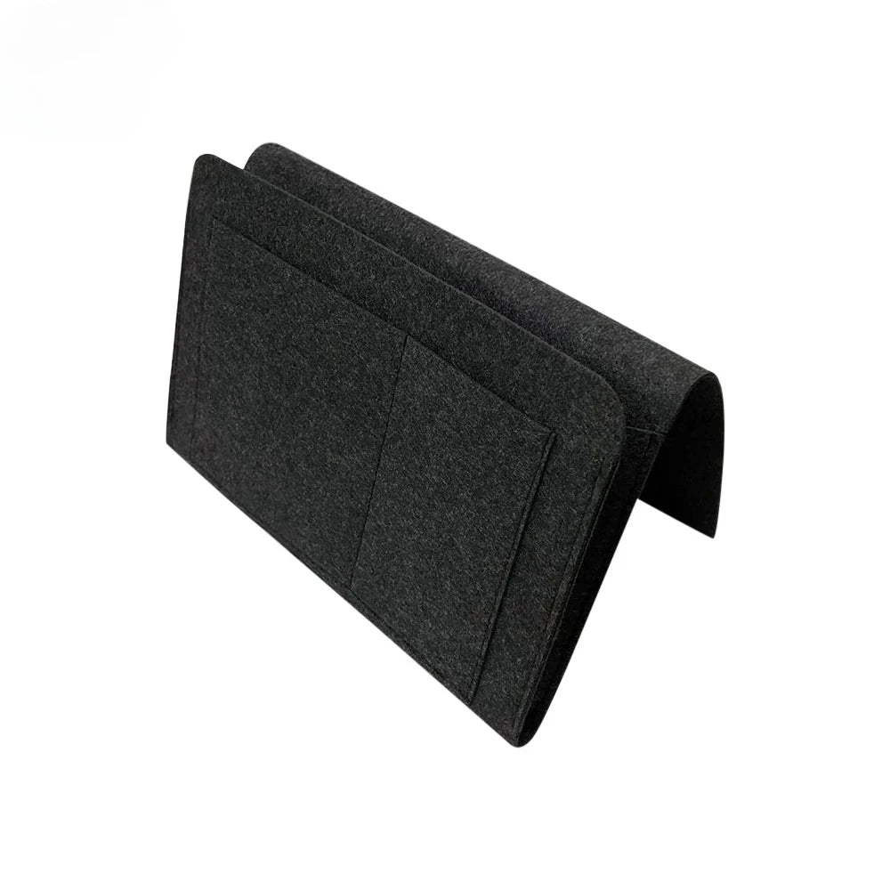 Black felt bedside storage organizer with a hanging pocket