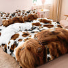 A bedding set featuring a print of Highland cows in brown and black on white fabric.